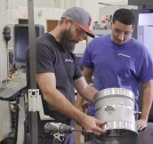 engineers inspecting a part for military equipment manufacturing engineers inspecting a part for military equipment manufacturing
