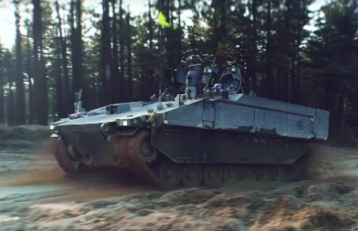 tracked military vehicle navigating a forest path during operations tracked military vehicle navigating a forest path during operations
